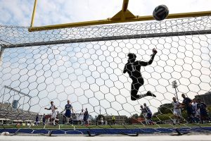 TORONTO, ON - Aug 29, 2015 : Ontario University Athletics Soccer Game Action between Ryerson Rams and University of Toronto Varsity Blues. Praveen Ahilan #1 of Ryerson Rams leaps high and pushes the ball over the ball out of play. (Courtesy Alex D'Addese/Ryerson Rams Athletics)