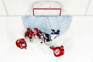 TORONTO , ON - Feb 5, 2015 : Ontario University Athletics Mens Hockey game action between the Ryerson Rams and the York Lions. Kyle Blaney #16 flies through the air after being tripped and deking the York Lion goaltender to score during first period game action. This photo came in second place in the 2014-2015 OUA Photo of the Year contest. "It's the type of photo you would see in Sports Illustrated," Jim McLarty, Ryerson Athletics' communications and new media coordinator, said in an e-mail. (Courtesy Alex D'Addese/Ryerson Rams Athletics)