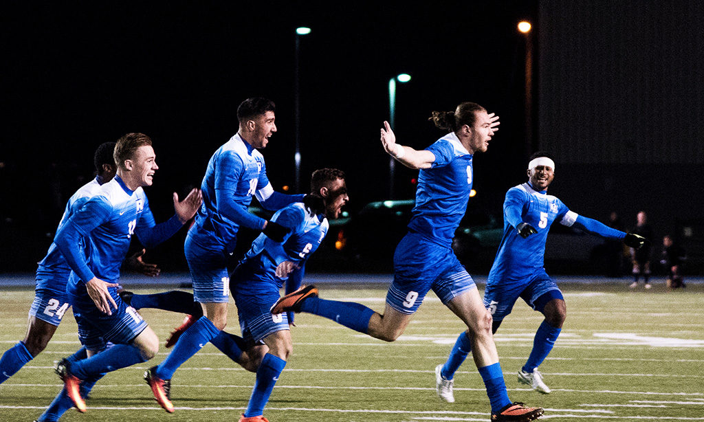 The Ryerson Men’s soccer team celebrates Jamie Baker’s game-winning goal on Sunday during their quarterfinal match-up. (Tagwa Moyo)