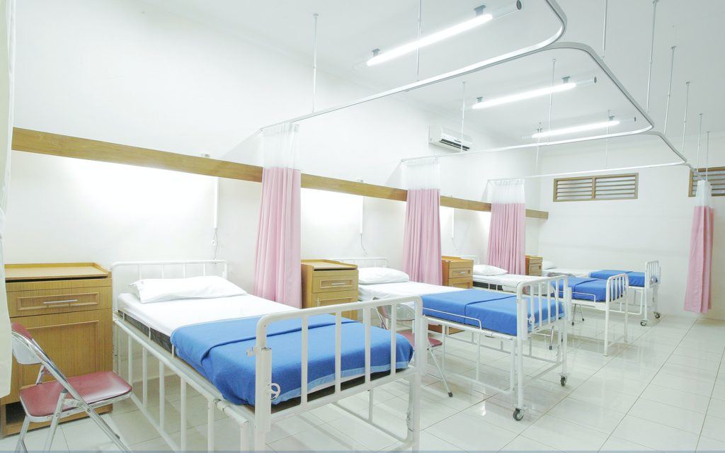 empty hospital beds in a row 