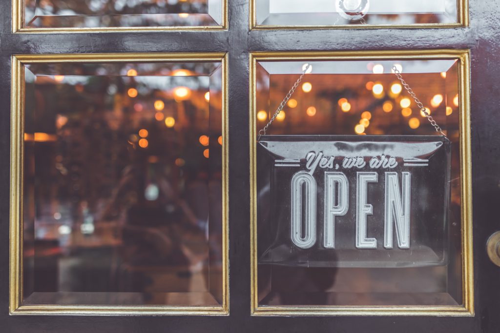 the door of a store that says open on it