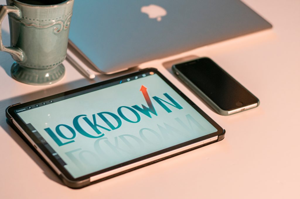 an ipad on a desk with the word "lockdown" written on it 