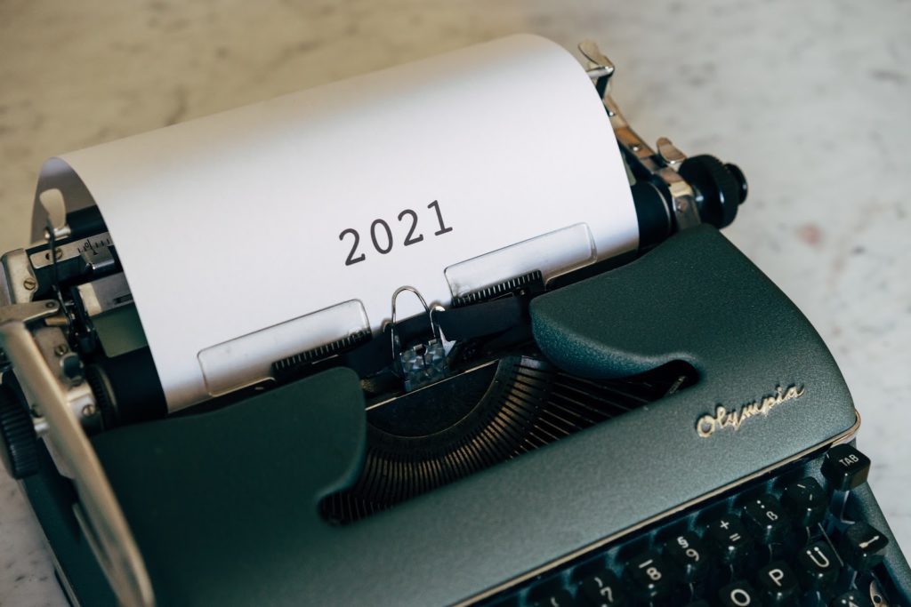 a typewriter that has the year 2021 written on a paper attached to it