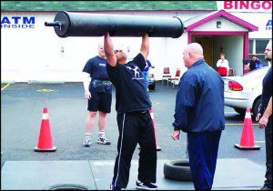 Sam Walls lifts a massive metal weight at an Ontario Strongman competition. (Courtsey teambarbarian.com)