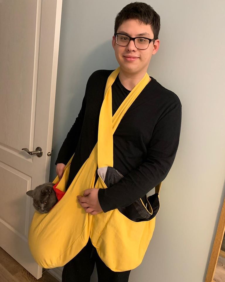 A boy wearing a yellow cross-body pouch