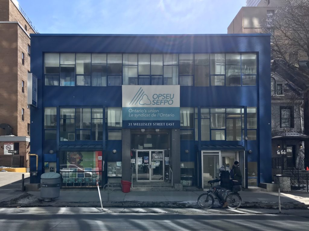 the outside of a blue OPSEU building on a sunny day