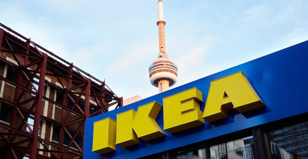 the IKEA sign in the foreground with the CN tower behind it 